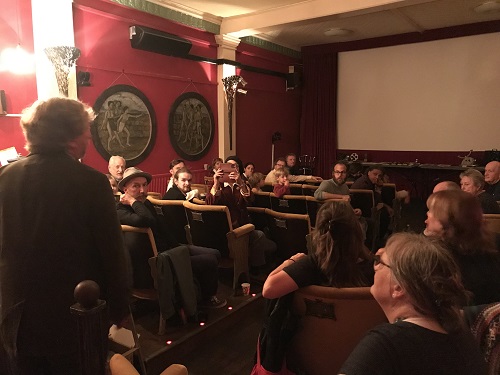 Group of volunteers looking at carl potter projecting a film